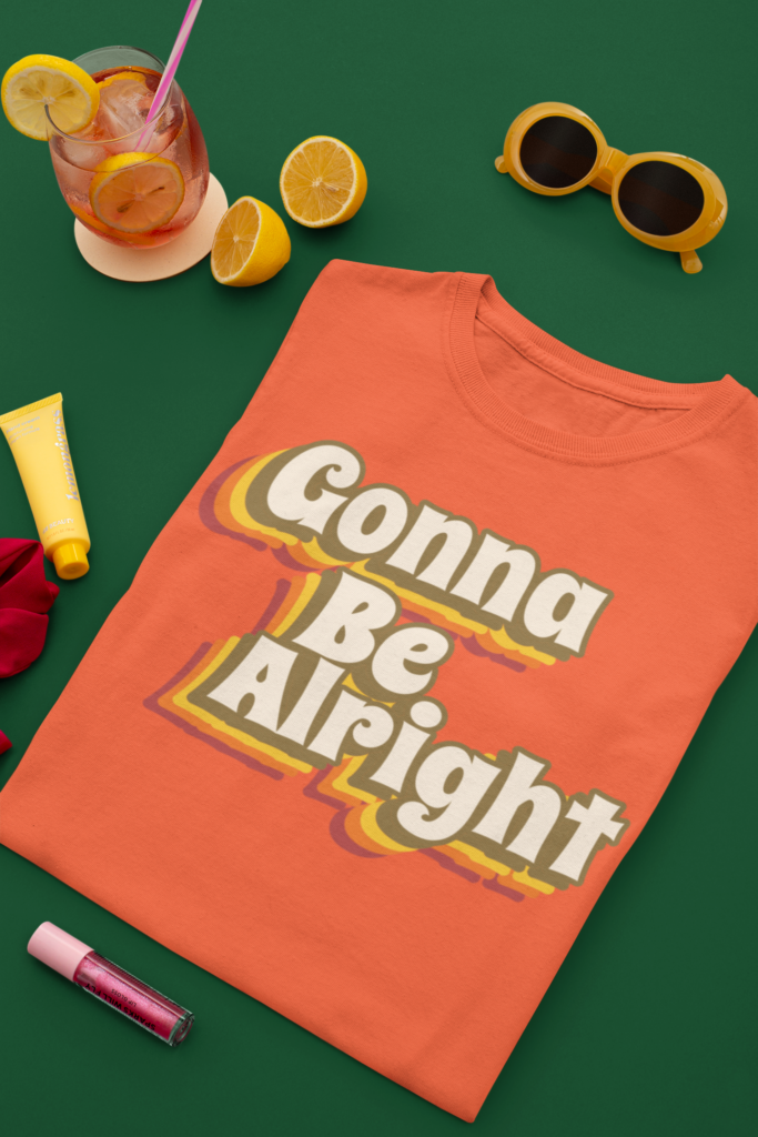 Gonna Be alright - Positive T shirt message mockup-of-a-folded-t-shirt-next-to-a-cocktail-m1676